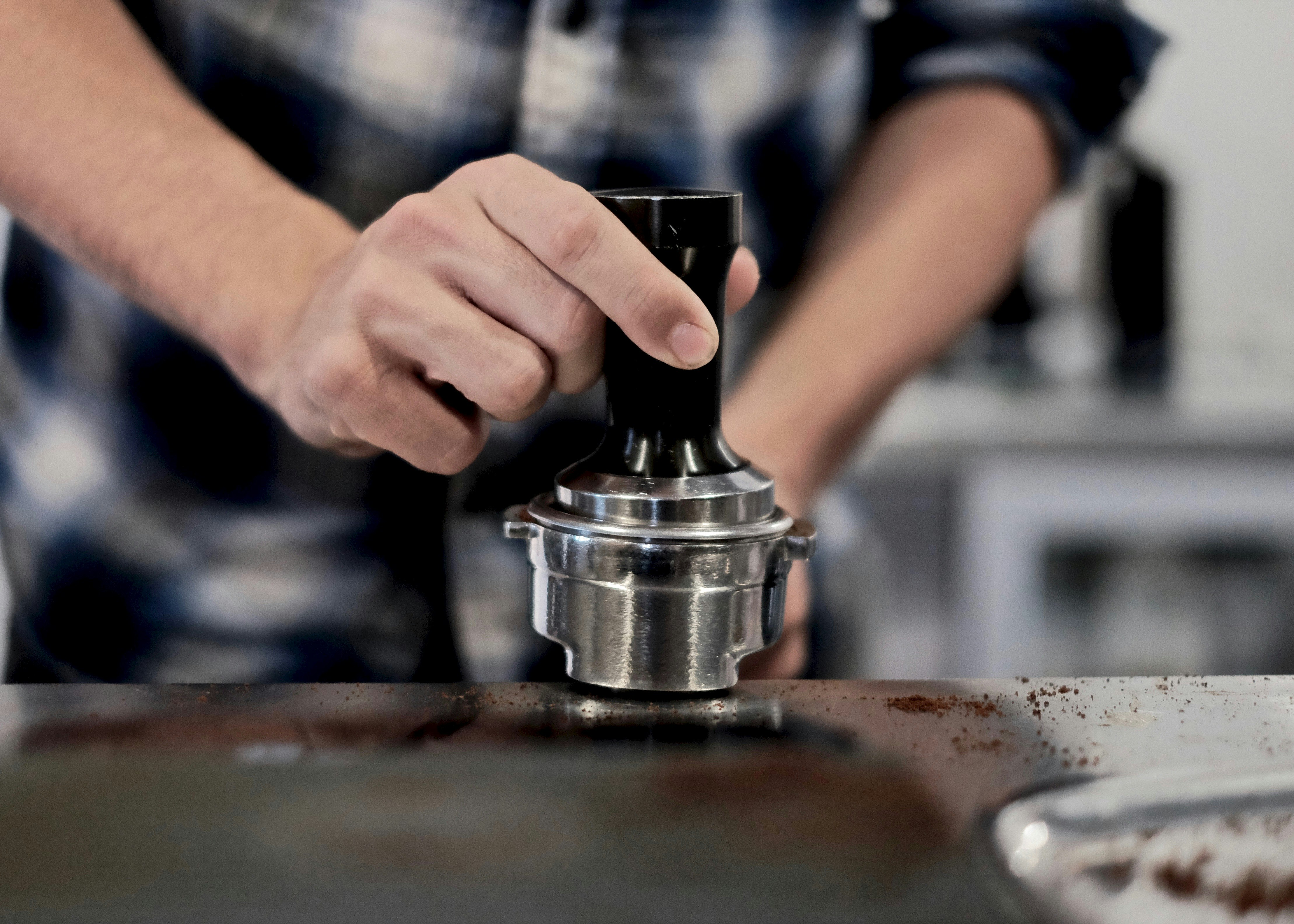 person holding grey metal tool